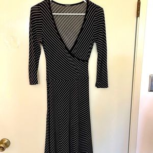 Wrap-style black dress with white stripes. Size small.